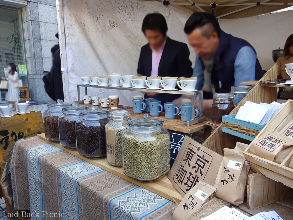 コーヒー豆の大きな瓶の後ろで、ドリップしている