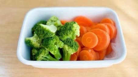The picture of boiled carrots and broccolis