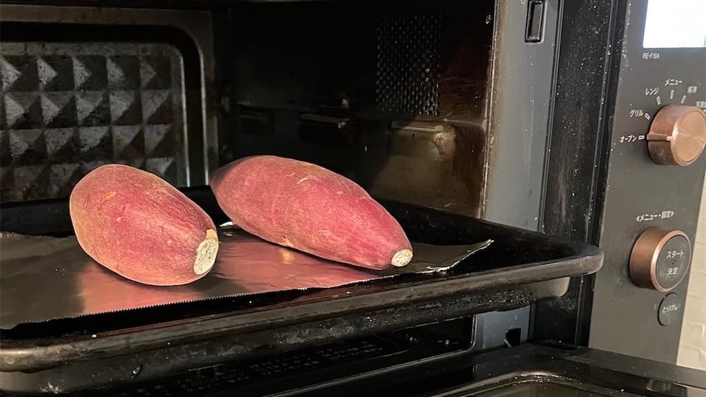 A picture of two sweet potatos put in the oven