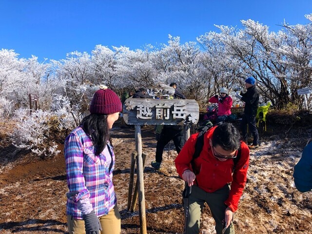 越前岳の山頂に到着した登山者達