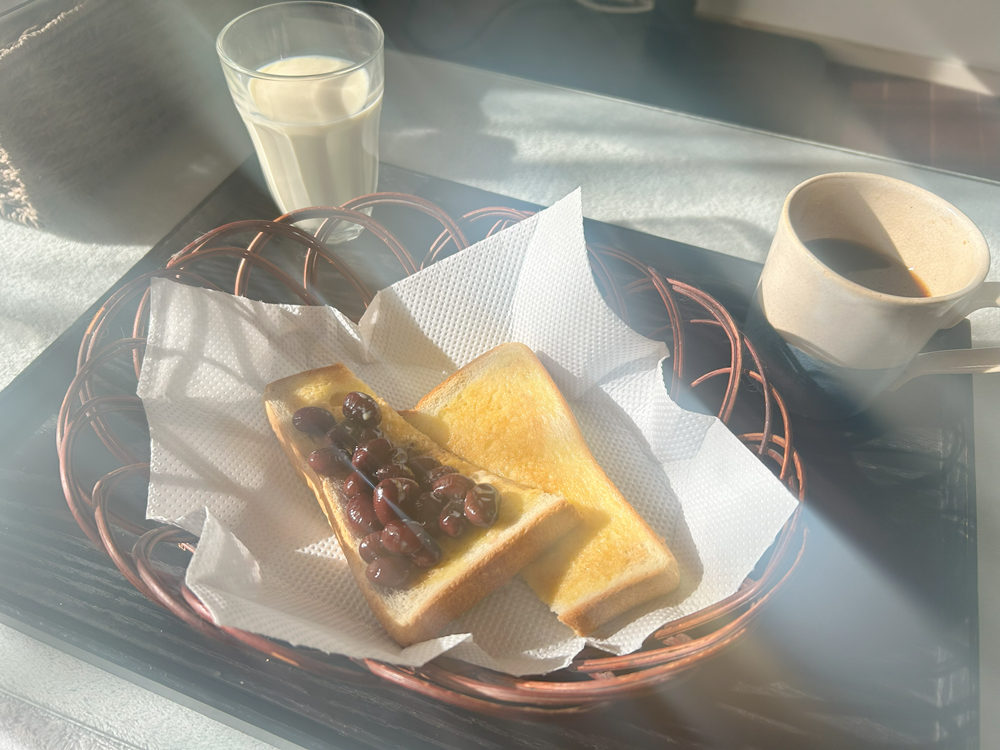 トーストにバターと黒豆を乗せた朝食の画像