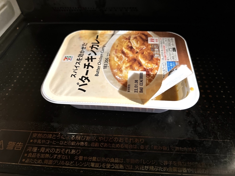 セブンイレブンの冷凍バターチキンカレーを電子レンジで温めようとしている写真