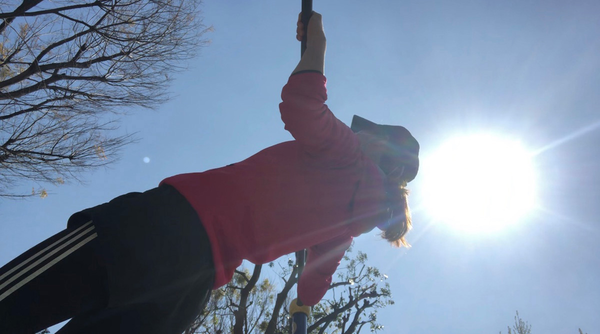 下から鉄棒をもち、足を前方にもっていき身体が斜め45度の状態を作り出します。そこから背中と腕の筋肉を使って、肘を曲げながら身体を鉄棒に引き寄せていきます。