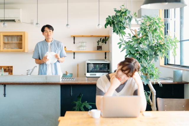 皿洗いとする男性と頭を抱える女性