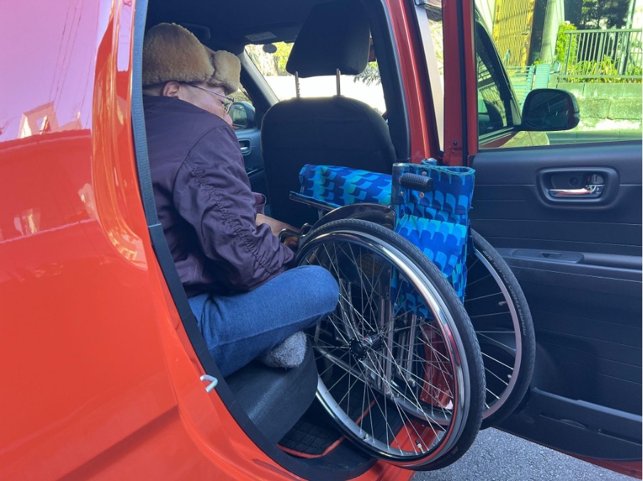 車椅子を積む男性