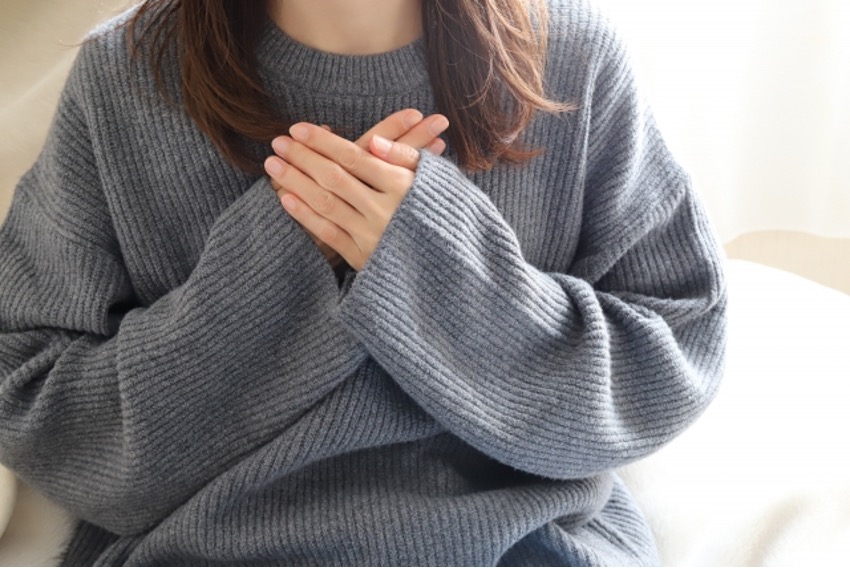 胸に手を当てる女性