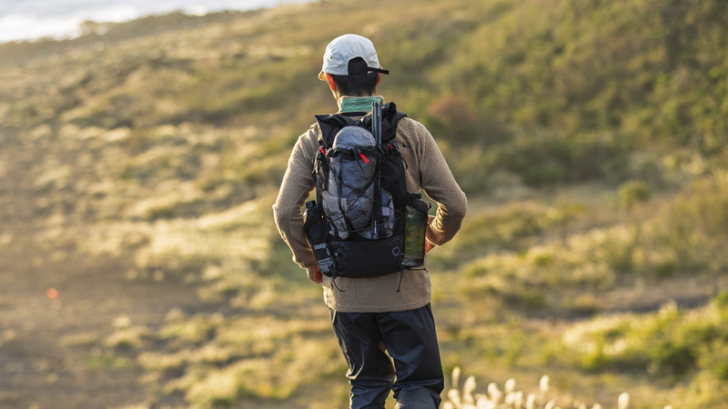 Hiker wearing Yamatomichi MINI2 on a trail