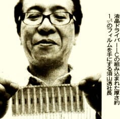 液晶ドライバーＩＣの組み込まれたフィルムを手にする須山透社長