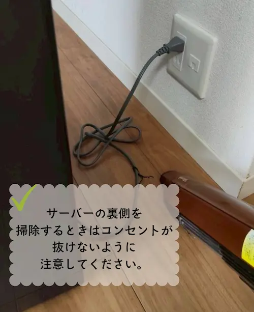 浄水型ウォーターサーバー・エブリィフレシャストールの裏側を掃除機で掃除する様子
