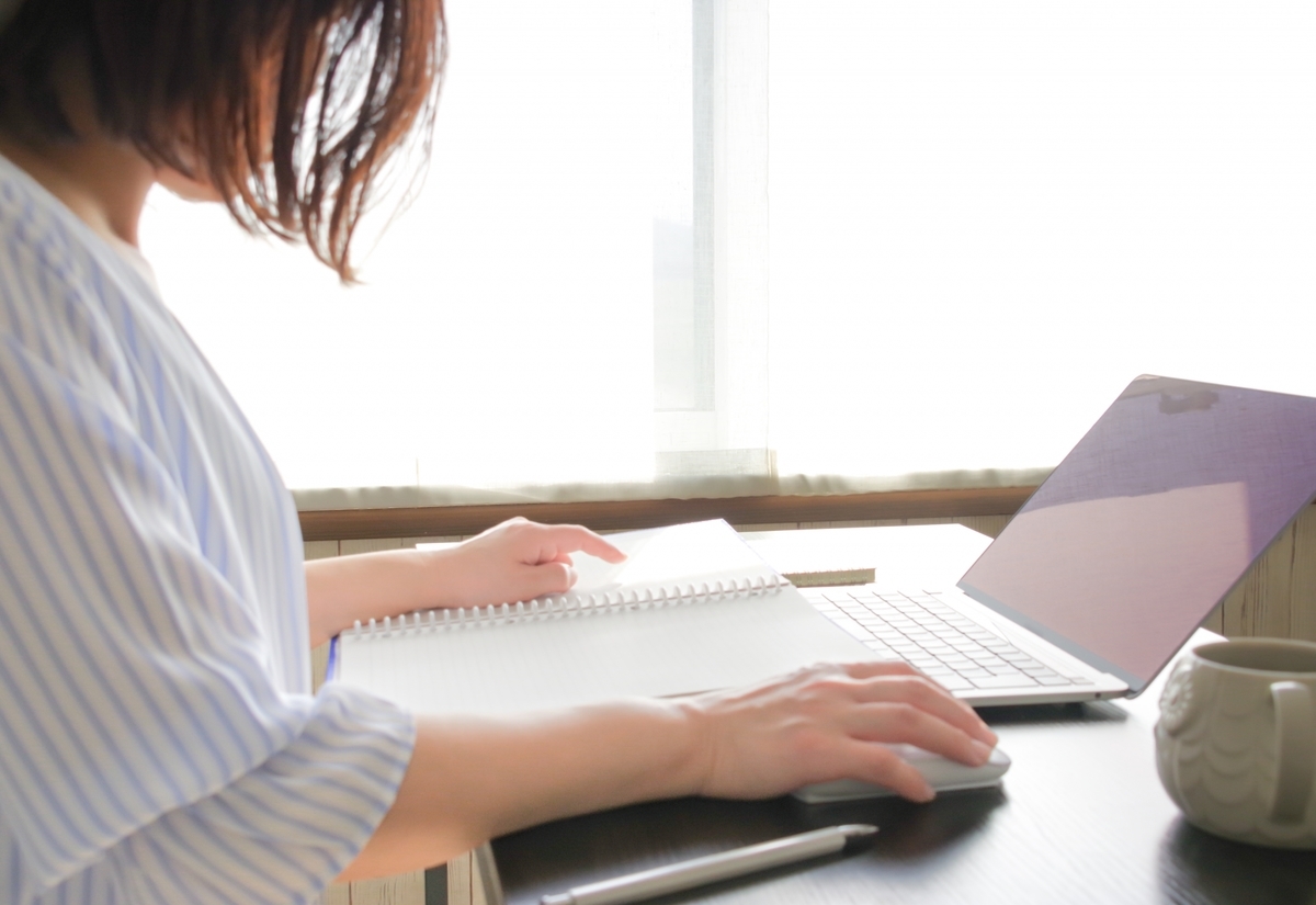 パソコンに向かい調べ物をする女性