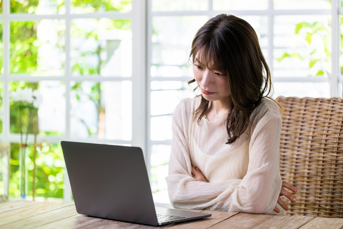 パソコンを見て考える女性