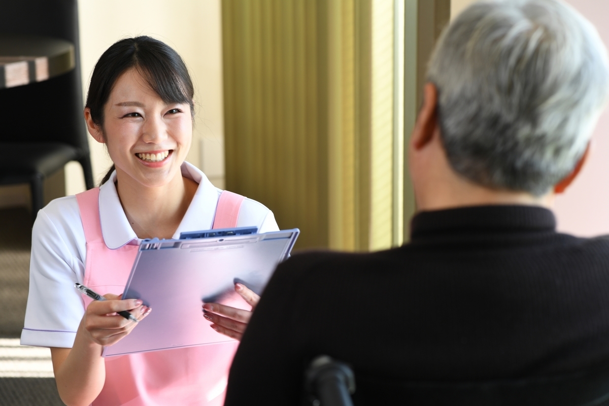 カルテを書く介護士の女性