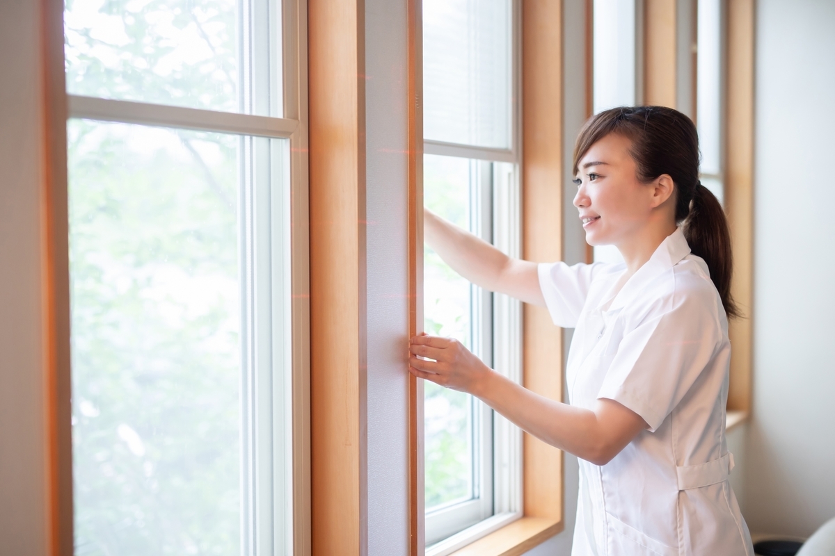 換気をする白衣の女性