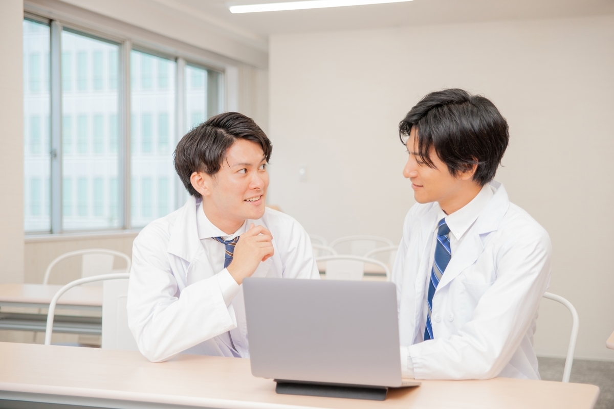 打ち合わせをする2人の白衣の男性