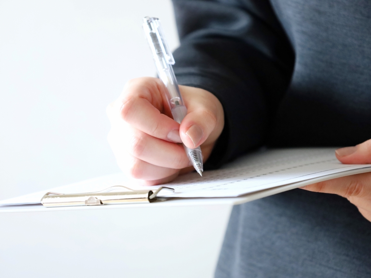 バインダーに記入する手元