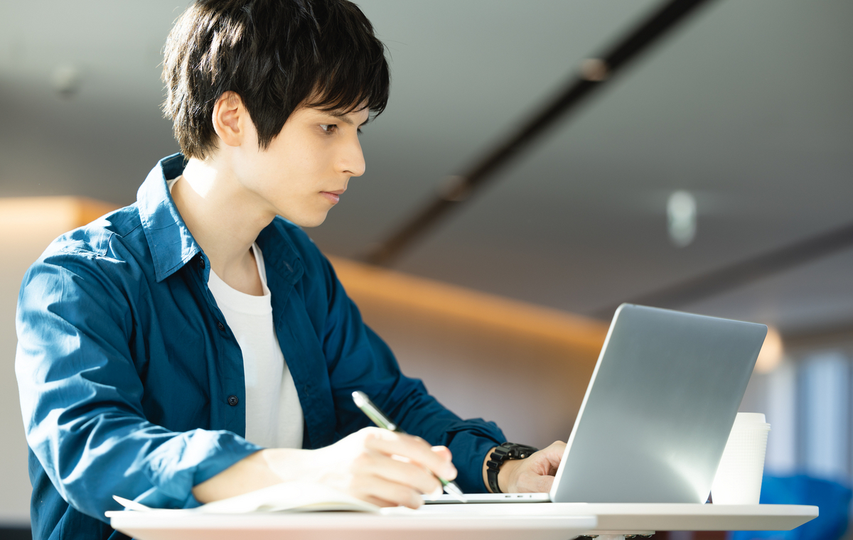 パソコンを見ながら勉強する男性