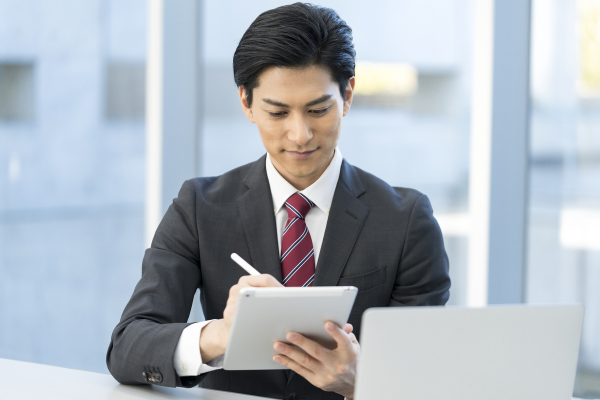 タブレットに記入する男性