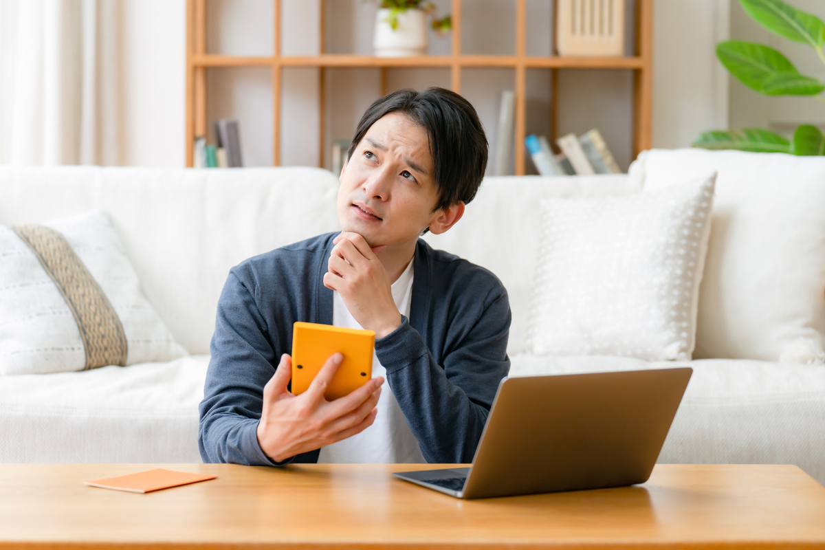 計算機を手に考える人物