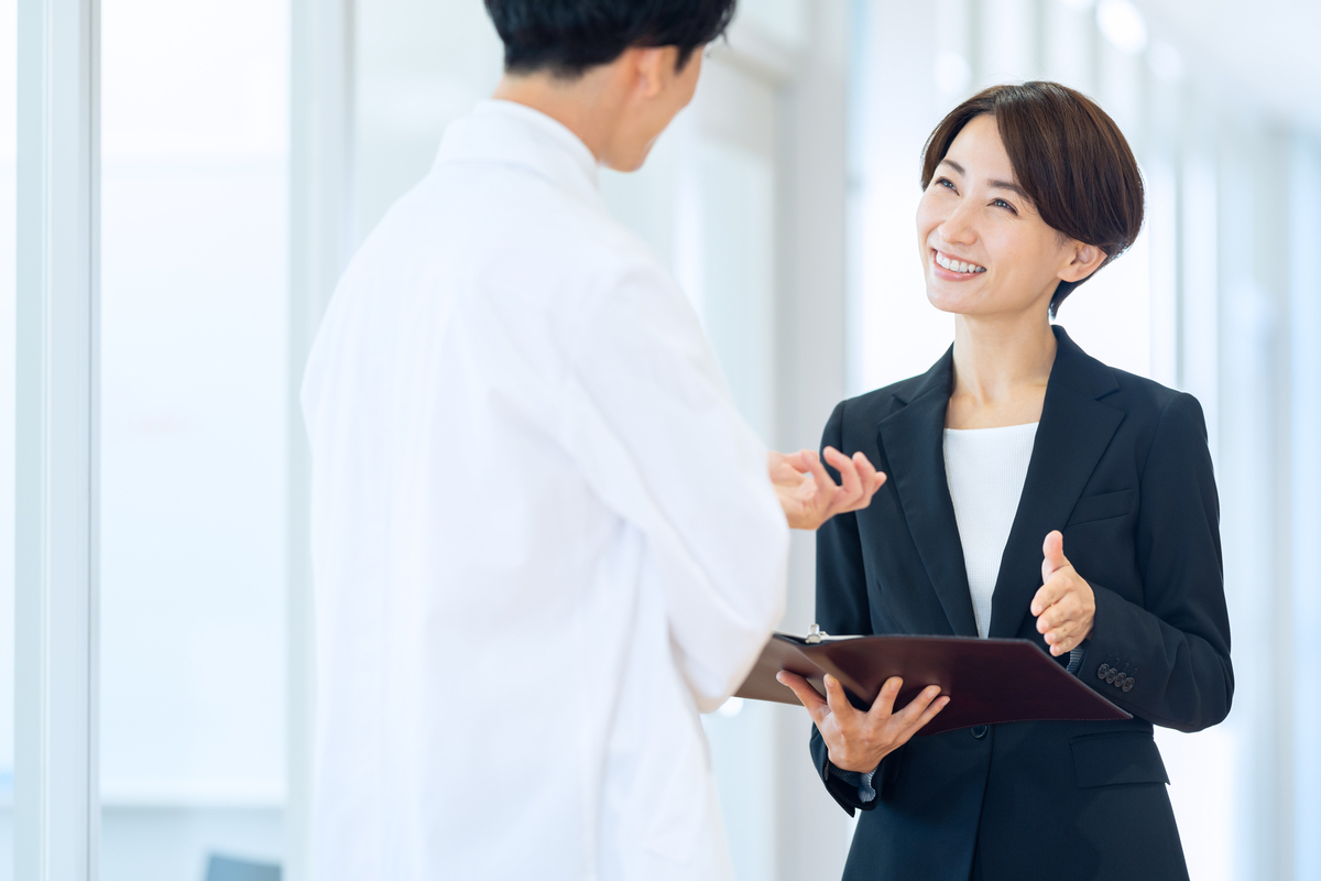 医師に笑顔で話をするMR