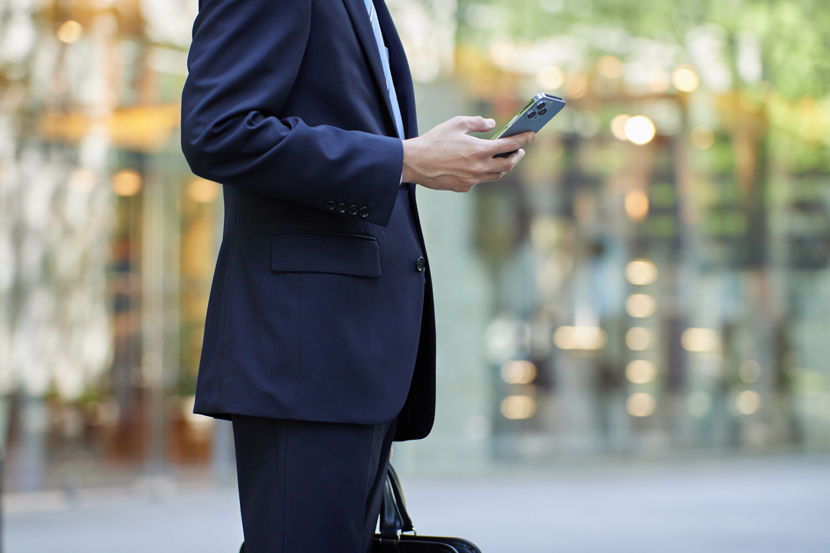スマホを操作するスーツの男性