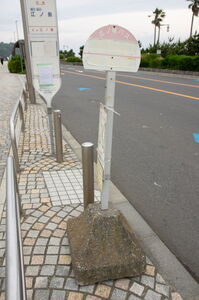 ボロボロの江ノ電バス江ノ島海岸バスポール。下部が欠損しており文字も消えてしまっている