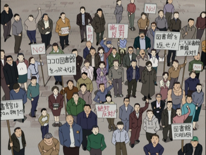 庁舎から見下ろす群集。図書館存続をうったえるさまざまなプラカードをかかげている。
