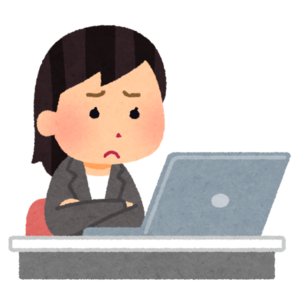 不満がある顔をしながら仕事をする人