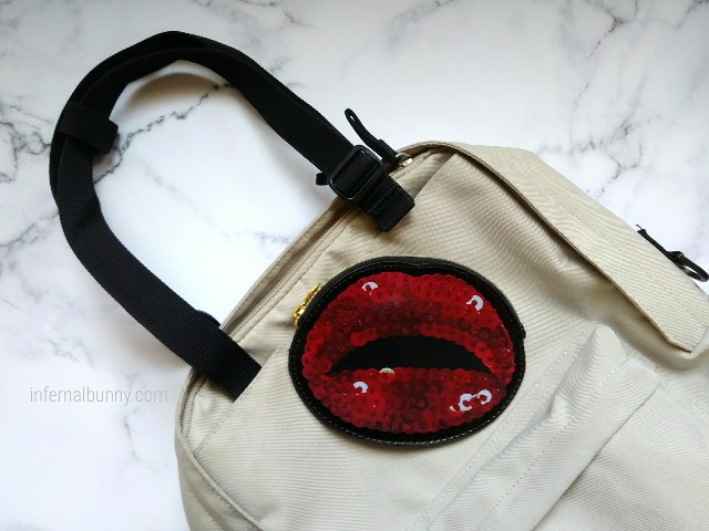 ベージュ色のリュックサックと、スパンコール柄の赤いフラットポーチ。