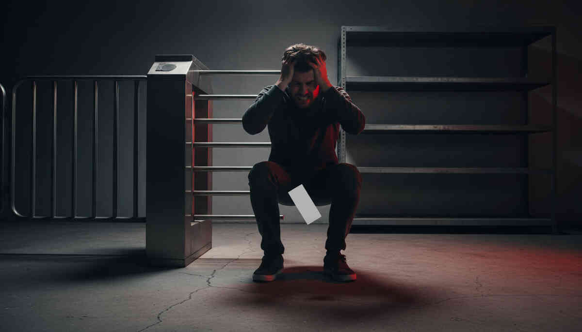 Devastated buyer collapsing near an empty entry gate as a ticket slips away—gut-punch disappointment, missed-by-seconds dread, cold silence after the rush