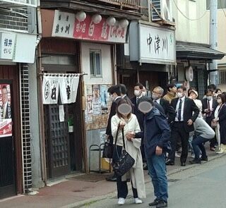 じゃじゃ麺の本店「白龍（パイロン）」の店先で並んで開店待ちする人々