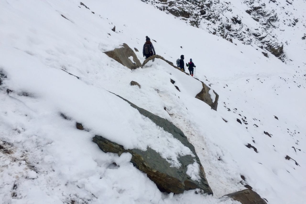 センチネルパスの雪に覆われた細い山道に岩がせり出している。