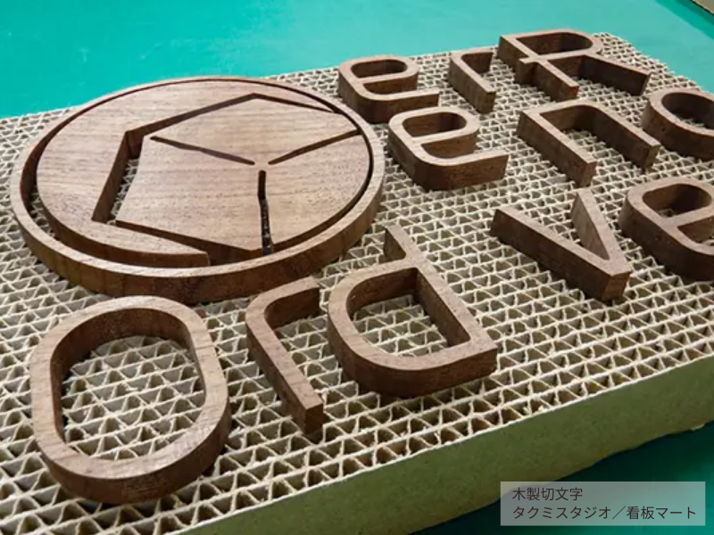 カフェやショップの外観にナチュラルな印象を与える木製切文字サイン。