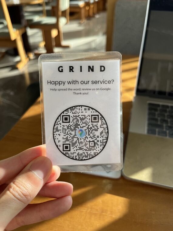 GRINDのラミネートカード。Happy with our service? Help spread the word; review us on Google. Thank you! の文字とQRコード