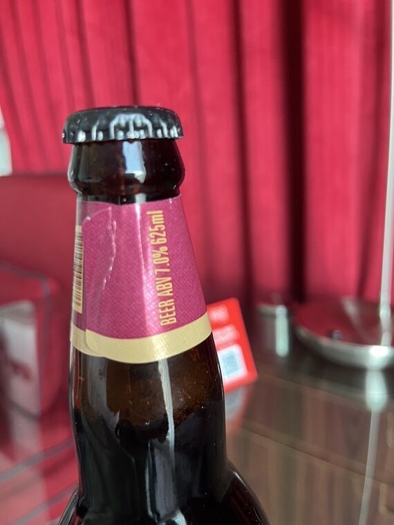 瓶の首のラベル。縦書きでBEER ABV 7.0% 625mlと金色の文字で印字されている