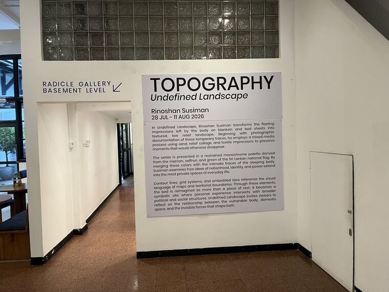 RADICLE GALLERY BASEMENT LEVELの案内と、TOPOGRAPHY Undefined Landscape、Rinoshan Susiman、28 JUL - 11 AUG 2026と書かれた展示パネル