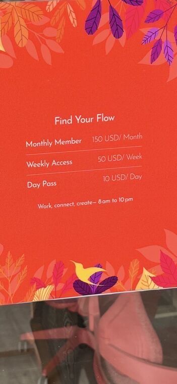 赤い掲示。Find Your Flowの見出しの下にMonthly Member 150 USD/Month、Weekly Access 50 USD/Week、Day Pass 10 USD/Dayと、Work, connect, create&ndash; 8am to 10pmの表記
