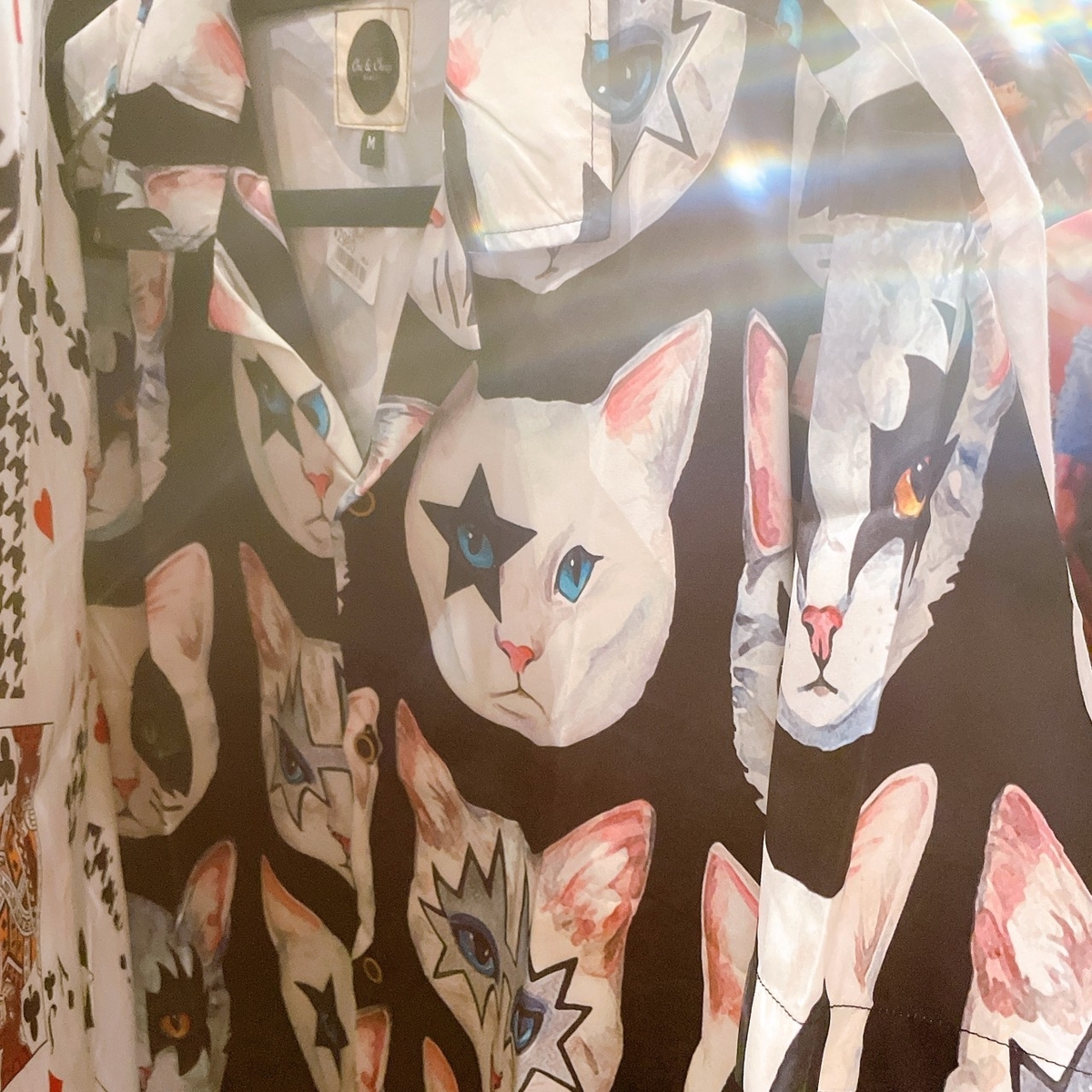 メタルバンドKISSのメイクをした猫の顔が沢山プリントされているシャツ