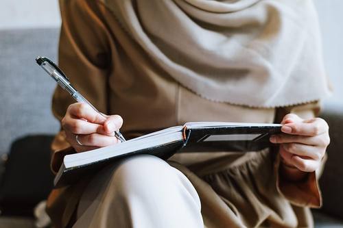 woman writing laptop