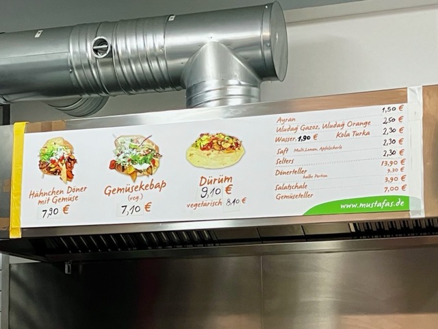 ケバブの人気店「Mustafa's」のメニューボード。価格や種類が記載されている