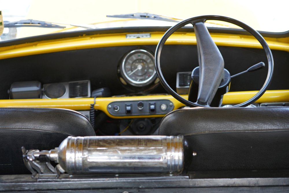 Interior of classic Mini van showing vintage fire extinguisher equipment detail