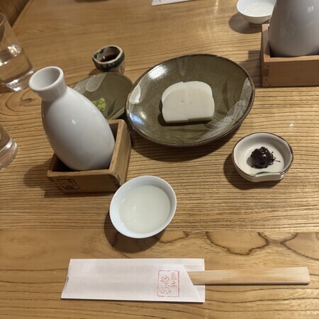 First, we'll take our time with lukewarm sake and sashimi served on a wooden board.