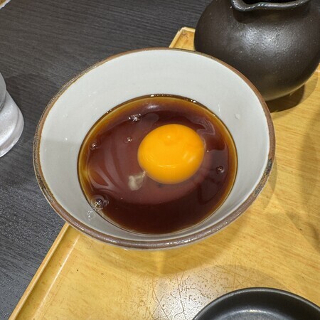 We ate the raw eggs by pouring the dipping sauce over them and stirring them up like this.