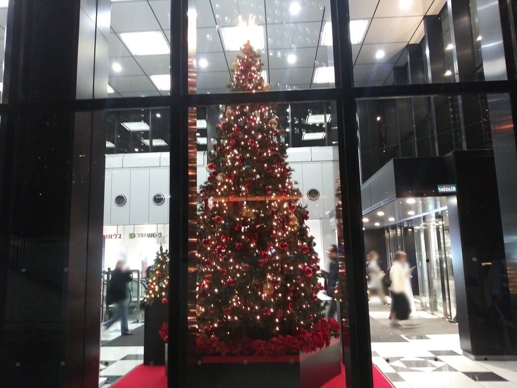 西新宿2_新宿三井ビルディングのクリスマスツリーを左側のガラス壁越しに外から撮影