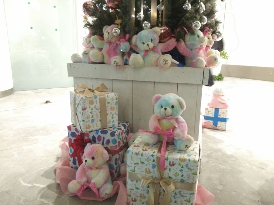 西新宿3_ワシントンホテル本館のクリスマスツリー　鉢の蕎麦にプレゼントとクマのぬいぐるみが置いてあるアップの写真