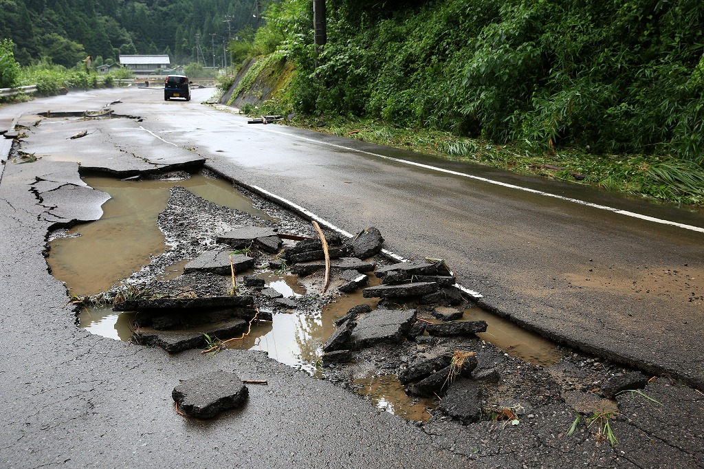 アスファルトが剥がれた道路=関市上之保・行合地区で