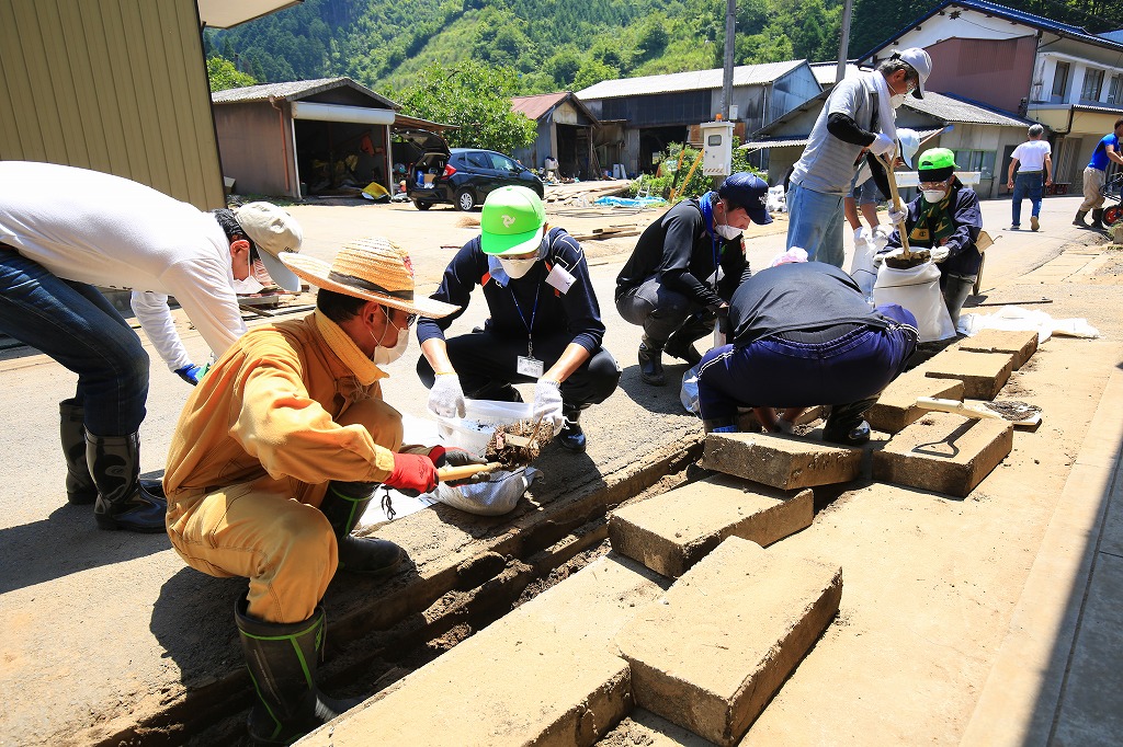 道路の脇にある側溝に泥が溜まり、水が流れない=関市上之保で