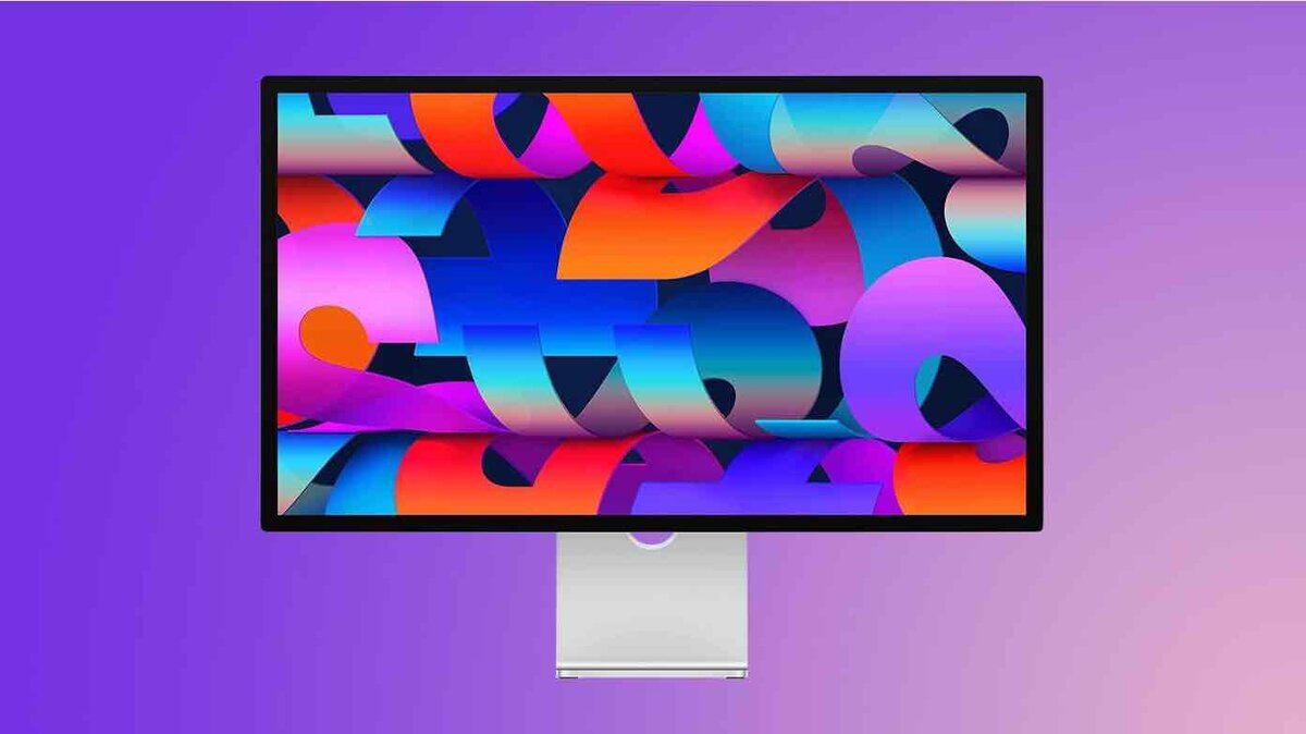 Appleの外部ディスプレイに鮮やかな多色の抽象アートが映し出された正面ビュー。背景は紫から薄いピンクへのグラデーション