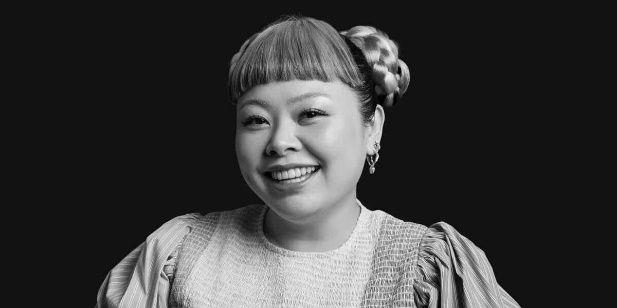 Apple Fitness+の日本向け特別プログラム「ウォーキングの時間」に登場する渡辺直美さんのモノクロポートレート。微笑みを浮かべた正面を向いた表情
