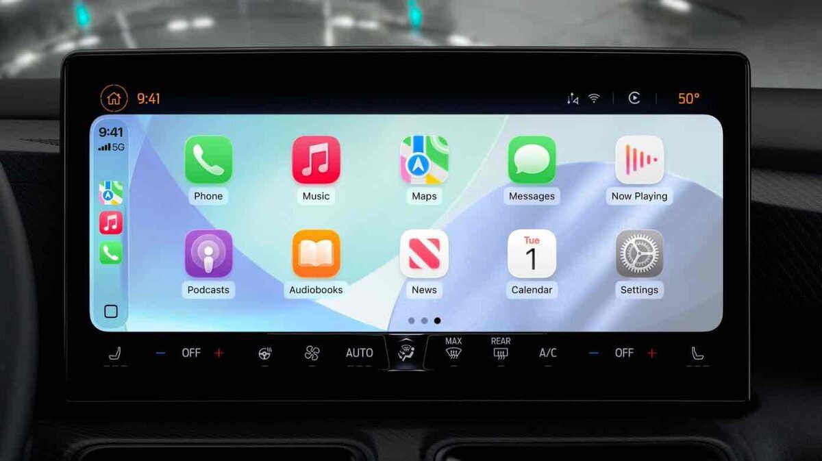 車載ディスプレイに表示されたApple CarPlayのホーム画面。Phone、Music、Maps、Messages、Now Playingなどのアプリアイコンが並び、下部にエアコン操作パネルが表示されている