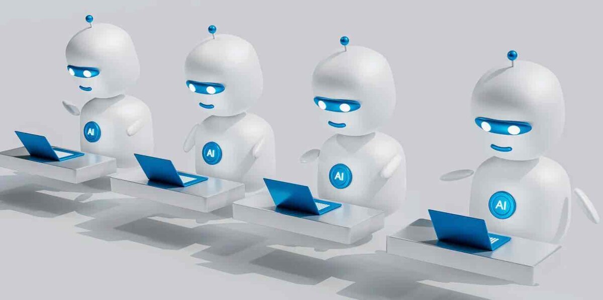 青い光る目を持つ4体の白い人型AIロボットが、デスクに並んで青いラップトップを操作している3Dイラスト。胸部には青いAIロゴが配置されている